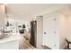 Modern kitchen with stainless steel appliances, bright countertops, and an open layout leading to a dining area at 115 W 2Nd Ave # 101, Denver, CO 80223