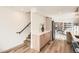 Open-concept kitchen featuring modern appliances, sleek countertops, and a view of the staircase and living area at 115 W 2Nd Ave # 101, Denver, CO 80223