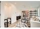 Inviting living room with modern furnishings, a sleek ceiling fan, and a sliding door with a brick wall view at 115 W 2Nd Ave # 101, Denver, CO 80223