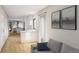 Open-concept living room and kitchen space featuring modern decor, light wood floors and lots of natural light at 115 W 2Nd Ave # 101, Denver, CO 80223
