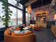 Cozy lounge area with a large window, orange seating, and a unique decorative wall at 115 W 2Nd Ave # 101, Denver, CO 80223
