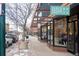 Street view of local retail businesses with unique signage and storefront displays at 115 W 2Nd Ave # 101, Denver, CO 80223