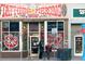 Eclectic tattoo and piercing shop exterior with colorful signage and window displays at 115 W 2Nd Ave # 101, Denver, CO 80223