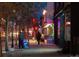 Nighttime street view with pedestrians, a vape shop with lighted signs, and active city life at 115 W 2Nd Ave # 101, Denver, CO 80223