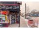 A snowy street corner with local bookstore and coffee shop named Mutiny Cafe at 115 W 2Nd Ave # 101, Denver, CO 80223