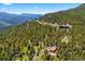 Aerial shot of mountain home amidst lush trees, showcasing scenic views and a peaceful setting at 187 Marion Dr, Evergreen, CO 80439