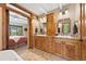 Bathroom with double vanities, stone floors, and a connecting door to a bedroom at 187 Marion Dr, Evergreen, CO 80439