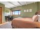 A cozy bedroom boasts white beamed ceilings, neutral decor, and a large window framing scenic mountain views at 187 Marion Dr, Evergreen, CO 80439