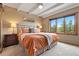 Comfortable bedroom with large window offering stunning views, and cozy furnishings at 187 Marion Dr, Evergreen, CO 80439