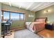 A nicely decorated bedroom features views from the window, light colored walls and a desk for work at 187 Marion Dr, Evergreen, CO 80439