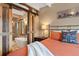 Bedroom view featuring a barn door leading to a luxurious ensuite bathroom with a soaking tub at 187 Marion Dr, Evergreen, CO 80439