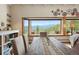 Bright dining room with mountain views, farmhouse table, and unique wheel art adding character at 187 Marion Dr, Evergreen, CO 80439