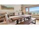Dining area featuring a long wooden table, bench seating, built-in shelving and mountain views at 187 Marion Dr, Evergreen, CO 80439