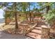 Inviting entrance with stone steps and beautiful landscaping leading to the home at 187 Marion Dr, Evergreen, CO 80439
