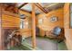 Wood paneled interior featuring rustic decor, seating, and natural light at 187 Marion Dr, Evergreen, CO 80439