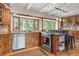 Bright kitchen with wood cabinets, stainless steel appliances, and large windows overlooking greenery at 187 Marion Dr, Evergreen, CO 80439