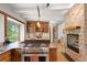 Modern kitchen features stone countertops, stainless steel range, and stone fireplace in open layout at 187 Marion Dr, Evergreen, CO 80439