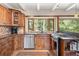 Charming kitchen boasts wood cabinetry, stainless steel appliances, and a picturesque window view at 187 Marion Dr, Evergreen, CO 80439