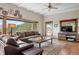Comfortable living room with a rustic coffee table, stone fireplace, and natural light from outside at 187 Marion Dr, Evergreen, CO 80439