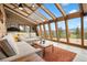 An inviting living room with floor-to-ceiling windows, wood beams, and natural light at 187 Marion Dr, Evergreen, CO 80439