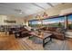 Open-concept living room with vaulted ceilings, leather seating, mountain views, and wood accents at 187 Marion Dr, Evergreen, CO 80439