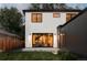 Exterior back view shows large windows and doors, modern paint scheme, manicured lawn, and fenced yard at 1117 S Madison St, Denver, CO 80210