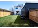 Expansive backyard with lush lawn, modern patio, and sleek exterior, ideal for outdoor living at 1117 S Madison St, Denver, CO 80210