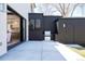 Stylish backyard with concrete patio, built-in grill, and sliding doors to bring the outside in at 1117 S Madison St, Denver, CO 80210