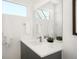 Sleek bathroom vanity with modern fixtures, a large mirror, and a decorative plant at 1117 S Madison St, Denver, CO 80210