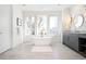 Bright bathroom with a soaking tub under three windows and a modern vanity at 1117 S Madison St, Denver, CO 80210