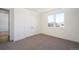 Bright bedroom with double closets, a large window, and neutral carpet at 1117 S Madison St, Denver, CO 80210