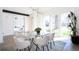 Bright dining room with large windows and a modern glass table perfect for Gathering meals at 1117 S Madison St, Denver, CO 80210
