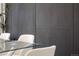 Close-up of a modern dining area with a glass table, chairs, and a stylish accent wall at 1117 S Madison St, Denver, CO 80210