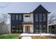 Modern two-story home with stylish black and white exterior, complemented by a well-manicured lawn at 1117 S Madison St, Denver, CO 80210