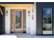 Close-up of a modern front door with a wooden frame, sleek lighting, and clear address display at 1117 S Madison St, Denver, CO 80210