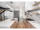 Contemporary kitchen featuring a spacious island, stainless steel appliances, and hardwood floors throughout at 1117 S Madison St, Denver, CO 80210