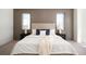 Comfortable bedroom features neutral decor, paneled wall, and plush bedding at 1117 S Madison St, Denver, CO 80210
