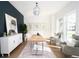 Bright office features a large window, a modern light fixture, and art on the wall at 1117 S Madison St, Denver, CO 80210