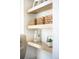 Close-up of built-in shelving featuring stylish decor and woven baskets at 1117 S Madison St, Denver, CO 80210