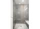Modern shower featuring gray tile, a glass door, and a built-in bench at 1117 S Madison St, Denver, CO 80210