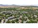 Scenic aerial view of a residential neighborhood with lush greenery and distant mountain views at 10567 Dartmouth, Lakewood, CO 80227