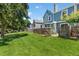 Lush green backyard with grass and a wooden fence at 10567 Dartmouth, Lakewood, CO 80227