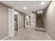 Finished basement featuring stairs, laundry, bathroom, and bonus room at 10567 W Dartmouth Ave, Lakewood, CO 80227