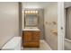 Basement bathroom featuring mirror, vanity, tile floor, and toilet at 10567 Dartmouth, Lakewood, CO 80227