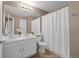 Bright bathroom with double sink vanity, a large mirror, and a shower-tub combination at 10567 Dartmouth, Lakewood, CO 80227