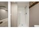 Walk-in shower featuring white tile in basement bathroom at 10567 Dartmouth, Lakewood, CO 80227