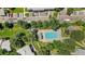 Overhead shot of a community pool surrounded by lush greenery and ample parking space at 10567 W Dartmouth Ave, Lakewood, CO 80227