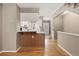 Inviting living area featuring hardwood floors that connect to the kitchen and entryway at 10567 W Dartmouth Ave, Lakewood, CO 80227