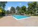 Community pool surrounded by trees and greenery at 10567 W Dartmouth Ave, Lakewood, CO 80227