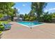 Community pool with clear blue water surrounded by lounge chairs at 10567 W Dartmouth Ave, Lakewood, CO 80227